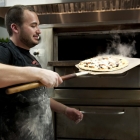 Tony Lemmo, one of the owners of Gusto Pizza, pulling out a divine pie
